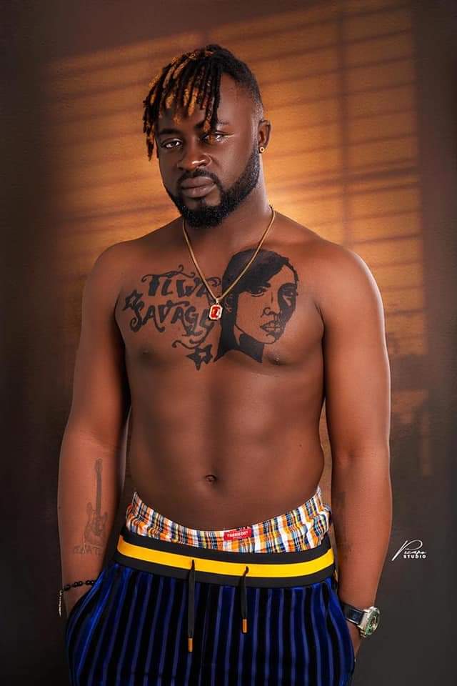 Cameroon Singer Olatokay tattoos Tiwa Savage’s face on his chest